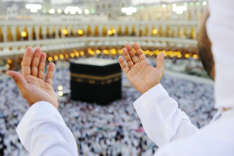 muslim praying mekkah with hands up